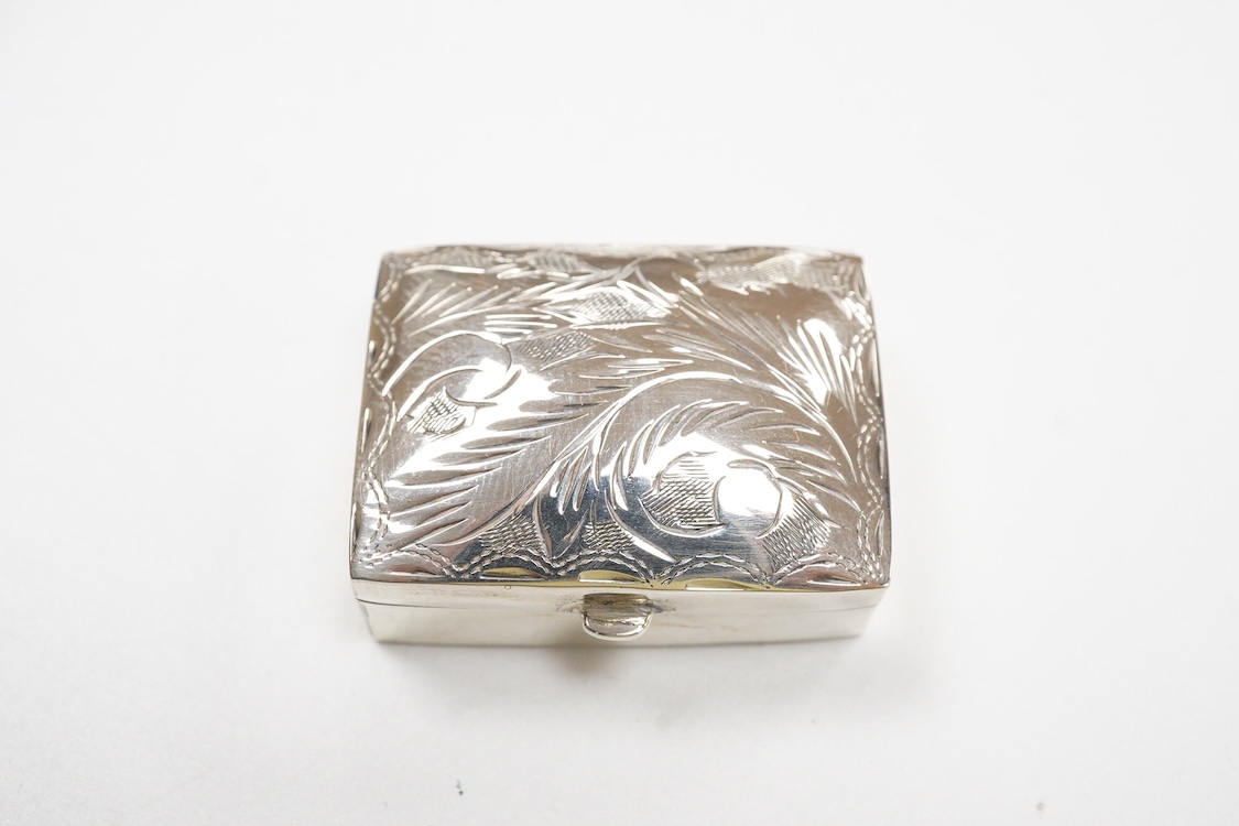 A Japanese white metal and polychrome enamel vesta case, decorated with flowers and butterfly, 56mm, together with a 19th century Russian 84 zolotnik and niello snuff box(tired), a modern silver pill box and a silver mou